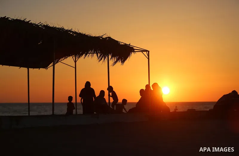 A Palestinian family gathers at the beach, during power cuts, to break their fast in Gaza City on May 31, 2017, during the Muslim Holy month of Ramadan. Ramadan is sacred to Muslims because it is during that month that t...