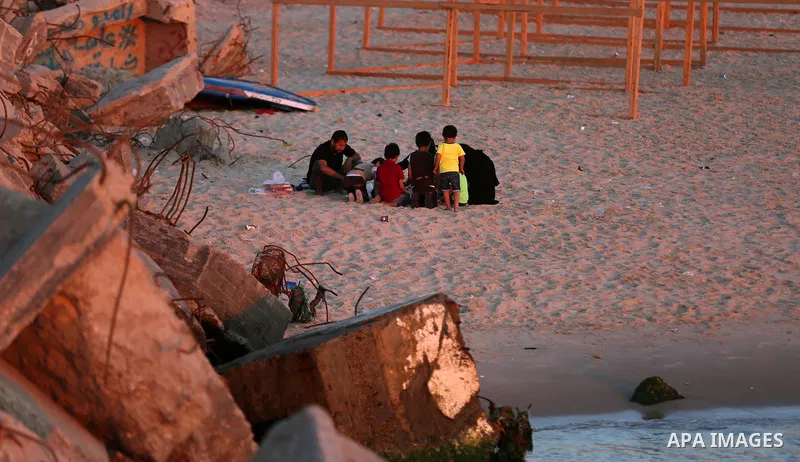 A Palestinian family gathers at the beach, during power cuts, to break their fast in Gaza City on May 31, 2017, during the Muslim Holy month of Ramadan. Ramadan is sacred to Muslims because it is during that month that t...