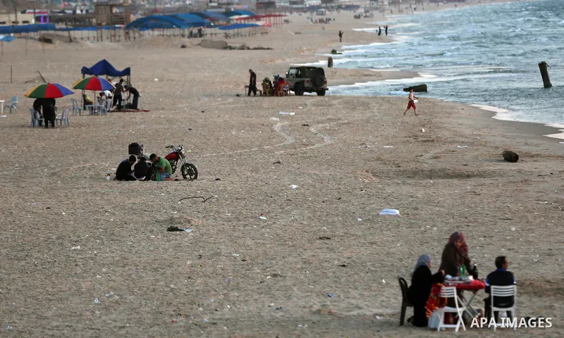 A Palestinian family gathers at the beach, during power cuts, to break their fast in Gaza City on May 31, 2017, during the Muslim Holy month of Ramadan. Ramadan is sacred to Muslims because it is during that month that t...
