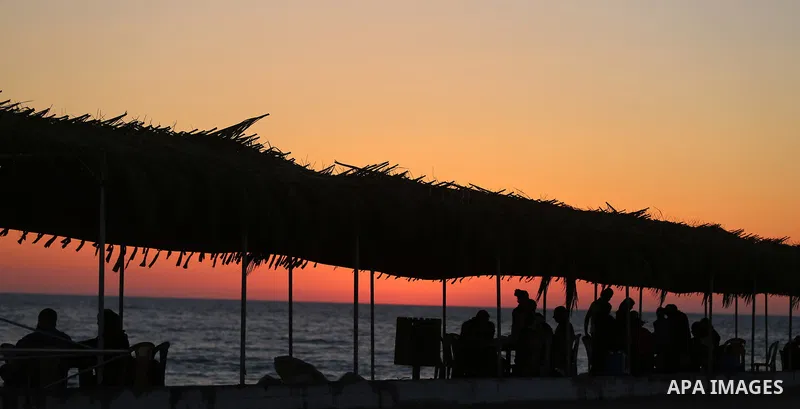 A Palestinian family gathers at the beach, during power cuts, to break their fast in Gaza City on May 31, 2017, during the Muslim Holy month of Ramadan. Ramadan is sacred to Muslims because it is during that month that t...