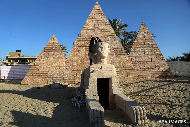 A Palestinian artist works on a wooden sculpture of sphinx at a technical site in the southern Gaza Strip town of Rafah, near the border with Egypt, on June 1, 2017. Young artists Palestinian artists Nidal Al-Jarami and...