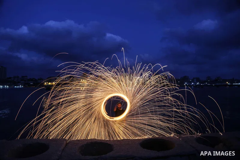 A Palestinian man plays with fire crackers celebrating on the holy month of Ramadan at the seaport of Gaza city, on June 1, 2017. Ramadan is sacred to Muslims because it is during that month that tradition says the Koran...