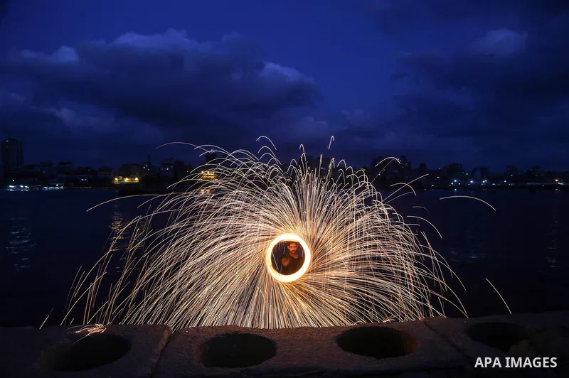 A Palestinian man plays with fire crackers celebrating on the holy month of Ramadan at the seaport of Gaza city, on June 1, 2017. Ramadan is sacred to Muslims because it is during that month that tradition says the Koran...