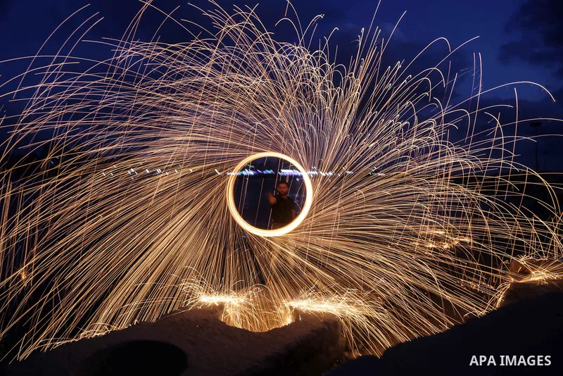 A Palestinian man plays with fire crackers celebrating on the holy month of Ramadan at the seaport of Gaza city, on June 1, 2017. Ramadan is sacred to Muslims because it is during that month that tradition says the Koran...