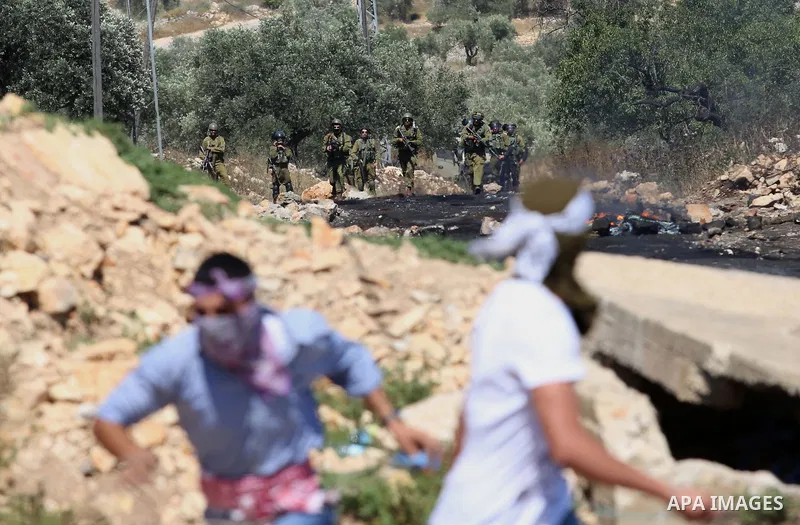 Palestinian protesters clash with Israeli security forces following a demonstration against the expropriation of Palestinian land by Israel in the village of Kfar Qaddum, near Nablus, in the occupied West Bank on June 2,...