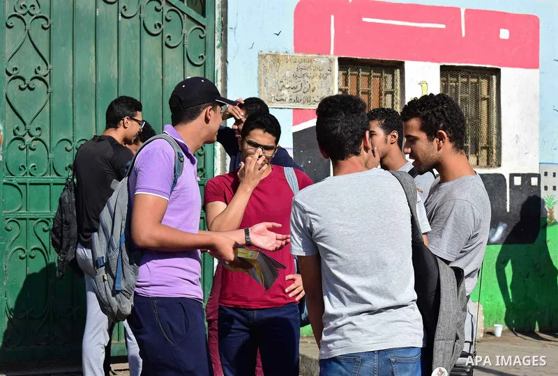 Egyptian students stand outside their school in the first day of high school exams, in Cairo, Egypt, on June 04, 2017. Photo by Amr Sayed