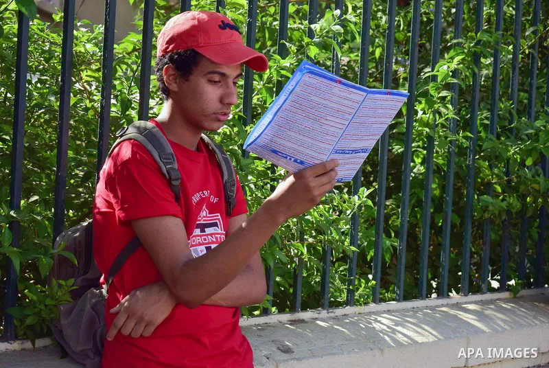 An Egyptian student stands outside his school in the first day of high school exams, in Cairo, Egypt, on June 04, 2017. Photo by Amr Sayed