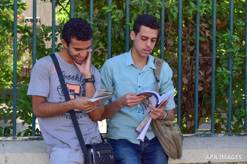 Egyptian students stand outside their school in the first day of high school exams, in Cairo, Egypt, on June 04, 2017. Photo by Amr Sayed