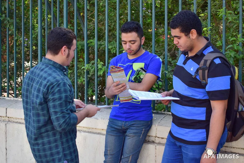 Egyptian students stand outside their school in the first day of high school exams, in Cairo, Egypt, on June 04, 2017. Photo by Amr Sayed
