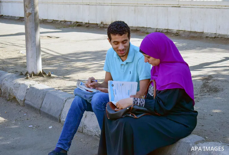 An Egyptian student and his mother outside his school in the first day of high school exams, in Cairo, Egypt, on June 04, 2017. Photo by Amr Sayed