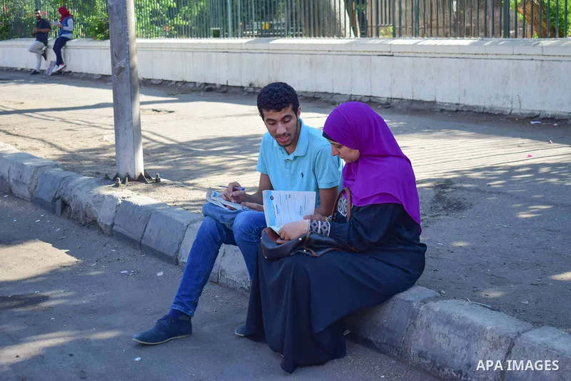 An Egyptian student and his mother outside his school in the first day of high school exams, in Cairo, Egypt, on June 04, 2017. Photo by Amr Sayed