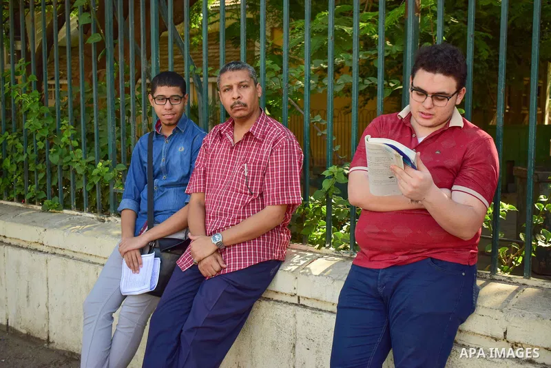 Egyptian students stand outside their school in the first day of high school exams, in Cairo, Egypt, on June 04, 2017. Photo by Amr Sayed