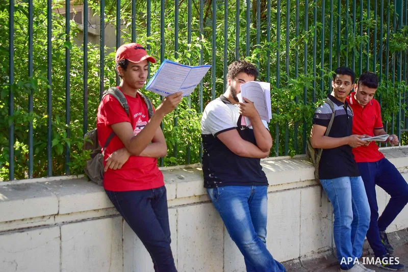 Egyptian students stand outside their school in the first day of high school exams, in Cairo, Egypt, on June 04, 2017. Photo by Amr Sayed