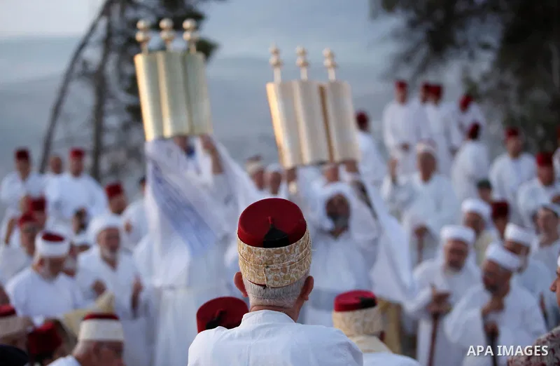 Samaritan worshipers pray on the top of Mount Gerizim in a traditional pilgrimage to mark the Shavuot's holiday at dawn near the West Bank city of Nablus June 4, 2017 which is giving of the Torah at Mount Sinai seven wee...