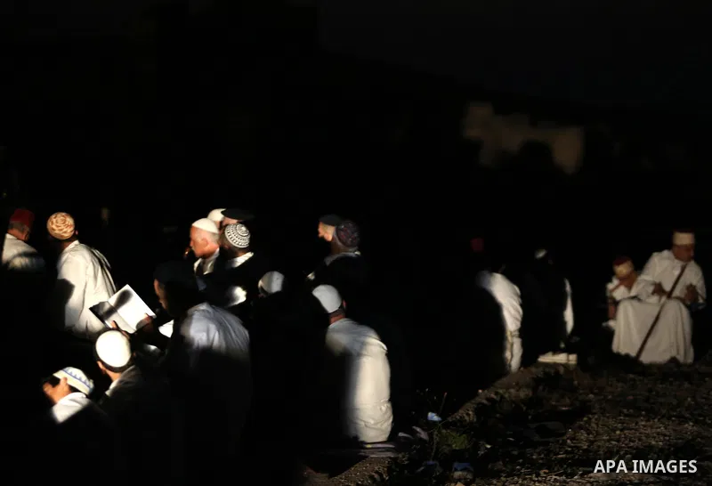 Samaritan worshipers pray on the top of Mount Gerizim in a traditional pilgrimage to mark the Shavuot's holiday at dawn near the West Bank city of Nablus June 4, 2017 which is giving of the Torah at Mount Sinai seven wee...