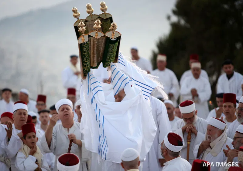 Samaritan worshipers pray on the top of Mount Gerizim in a traditional pilgrimage to mark the Shavuot's holiday at dawn near the West Bank city of Nablus June 4, 2017 which is giving of the Torah at Mount Sinai seven wee...