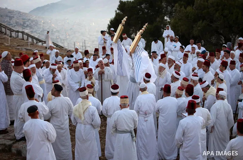 Samaritan worshipers pray on the top of Mount Gerizim in a traditional pilgrimage to mark the Shavuot's holiday at dawn near the West Bank city of Nablus June 4, 2017 which is giving of the Torah at Mount Sinai seven wee...