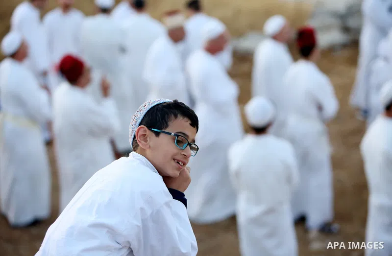 A young Samaritan prays on the top of Mount Gerizim in a traditional pilgrimage to mark the Shavuot's holiday at dawn near the West Bank city of Nablus June 4, 2017 which is giving of the Torah at Mount Sinai seven weeks...