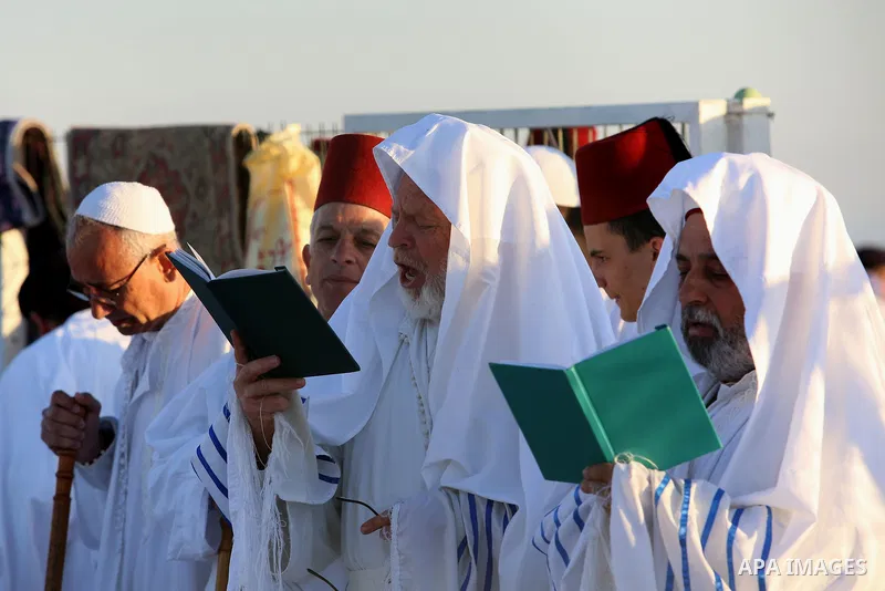Samaritan worshipers pray on the top of Mount Gerizim in a traditional pilgrimage to mark the Shavuot's holiday at dawn near the West Bank city of Nablus June 4, 2017 which is giving of the Torah at Mount Sinai seven wee...