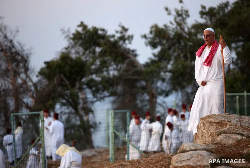 Samaritan worshipers pray on the top of Mount Gerizim in a traditional pilgrimage to mark the Shavuot's holiday at dawn near the West Bank city of Nablus June 4, 2017 which is giving of the Torah at Mount Sinai seven wee...