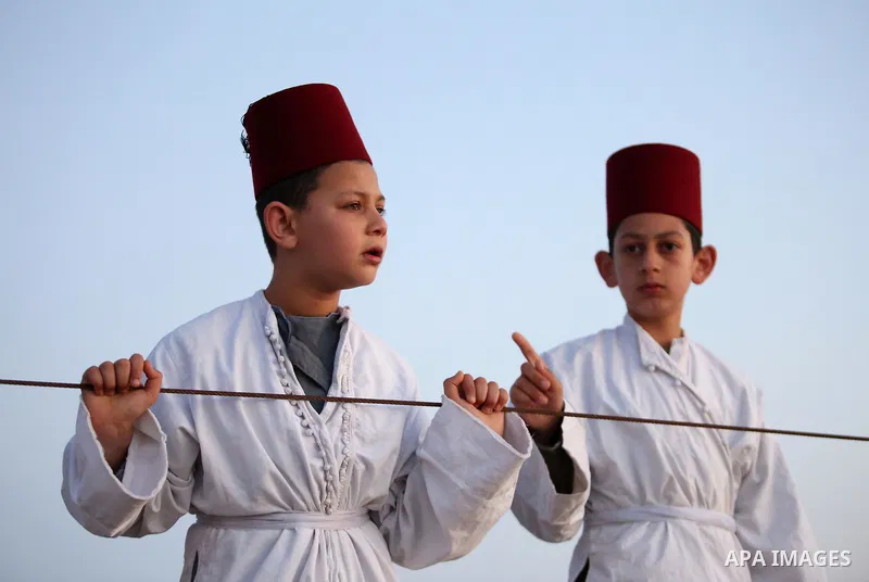 Samaritan children arrive to pray on the top of Mount Gerizim in a traditional pilgrimage to mark the Shavuot's holiday at dawn near the West Bank city of Nablus June 4, 2017 which is giving of the Torah at Mount Sinai s...