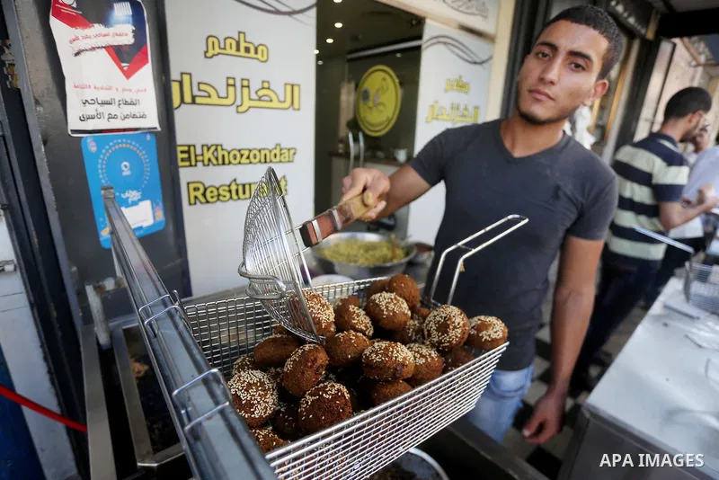 A Palestinian vendor prepares traditional chickpeas known as "Falafel" for breakfasting on the Muslim holy fasting month of Ramadan in Gaza city on June 05, 2017. Ramadan is sacred to Muslims because it is during that mo...