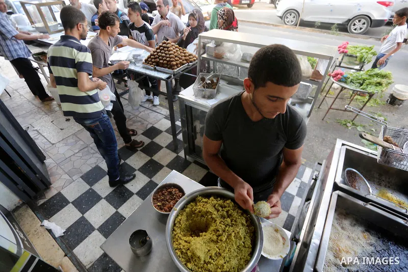 A Palestinian vendor prepares traditional chickpeas known as "Falafel" for breakfasting on the Muslim holy fasting month of Ramadan in Gaza city on June 05, 2017. Ramadan is sacred to Muslims because it is during that mo...