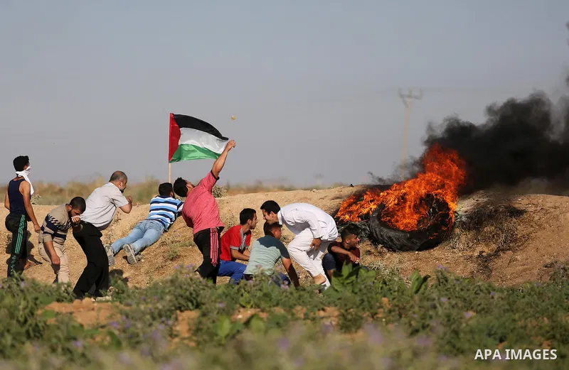 Palestinian protesters hurl stones towards Israeli security forces during clashes following a demonstration against the blockade on the Gaza Strip, near the border fence east of Jabalia refugee camp on June 5, 2017. Phot...