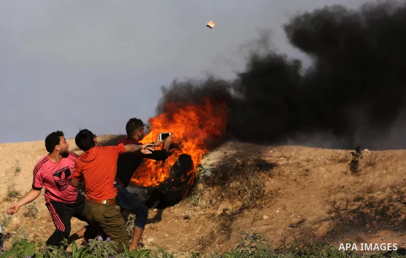 Palestinian protesters hurl stones towards Israeli security forces during clashes following a demonstration against the blockade on the Gaza Strip, near the border fence east of Jabalia refugee camp on June 5, 2017. Phot...
