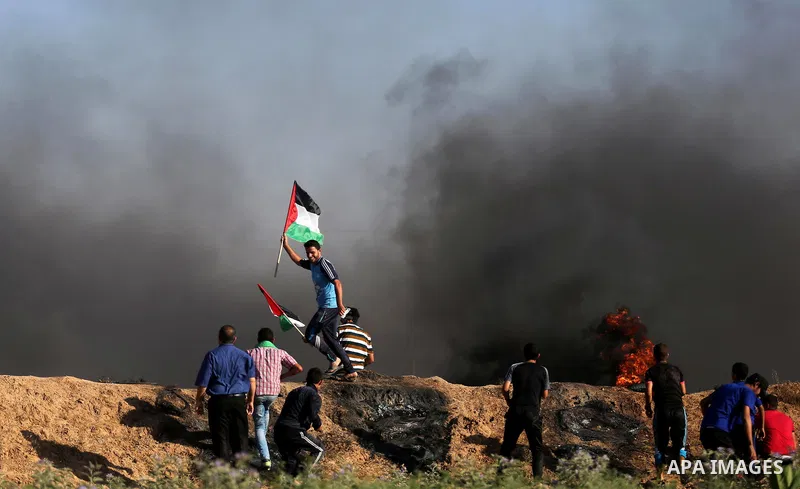 Palestinian protesters hurl stones towards Israeli security forces during clashes following a demonstration against the blockade on the Gaza Strip, near the border fence east of Jabalia refugee camp on June 5, 2017. Phot...
