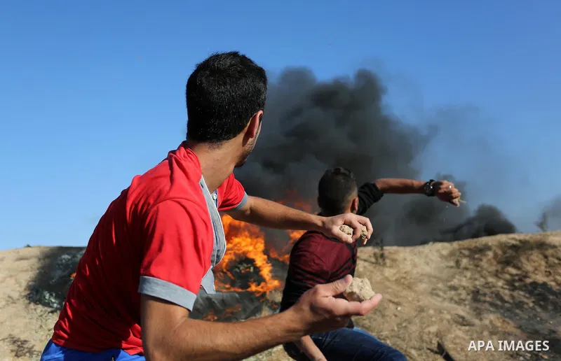 Palestinian protesters hurl stones towards Israeli security forces during clashes following a demonstration against the blockade on the Gaza Strip, near the border fence east of Jabalia refugee camp on June 5, 2017. Phot...