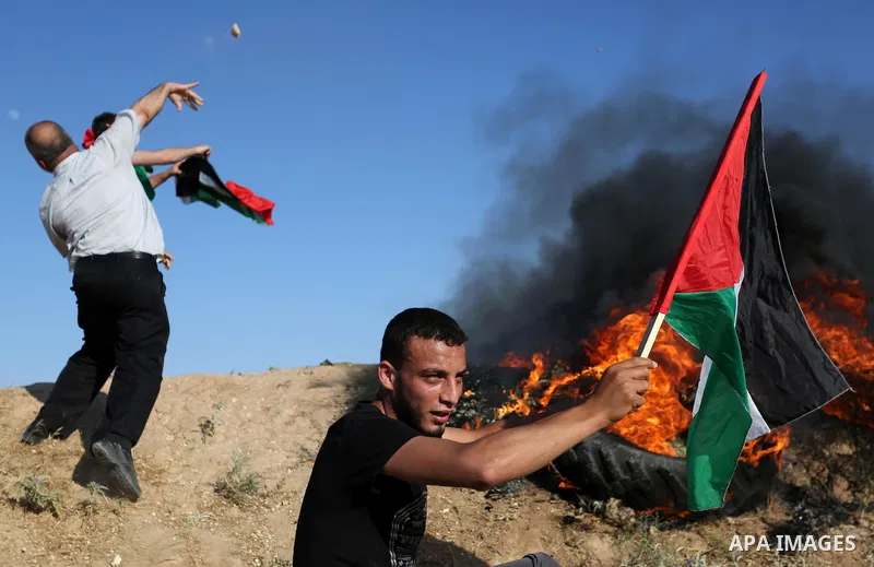 Palestinian protesters hurl stones towards Israeli security forces during clashes following a demonstration against the blockade on the Gaza Strip, near the border fence east of Jabalia refugee camp on June 5, 2017. Phot...