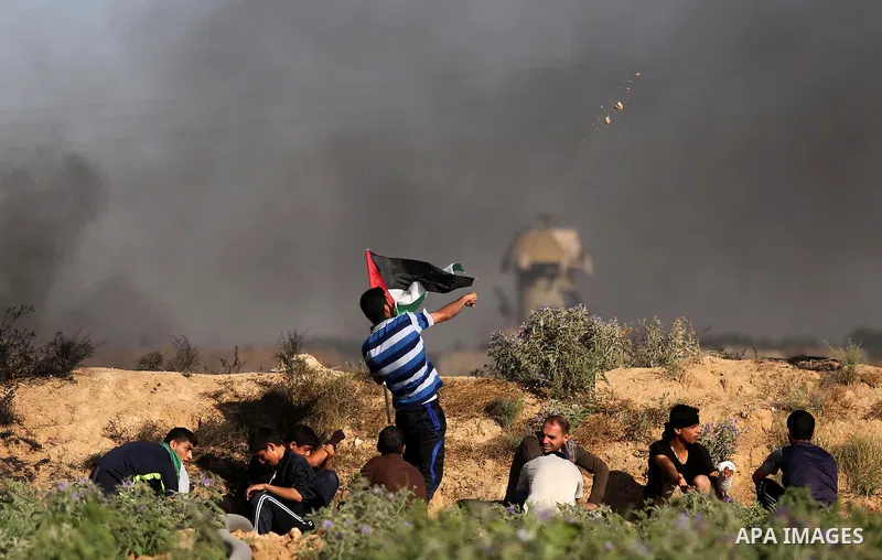 A Palestinian protester hurls stones towards Israeli security forces during clashes following a demonstration against the blockade on the Gaza Strip, near the border fence east of Jabalia refugee camp on June 5, 2017. Ph...