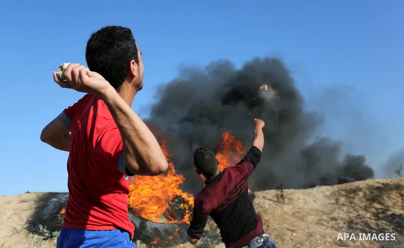 Palestinian protesters hurl stones towards Israeli security forces during clashes following a demonstration against the blockade on the Gaza Strip, near the border fence east of Jabalia refugee camp on June 5, 2017. Phot...