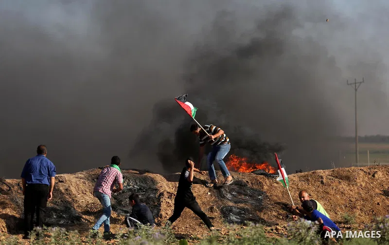Palestinian protesters hurl stones towards Israeli security forces during clashes following a demonstration against the blockade on the Gaza Strip, near the border fence east of Jabalia refugee camp on June 5, 2017. Phot...