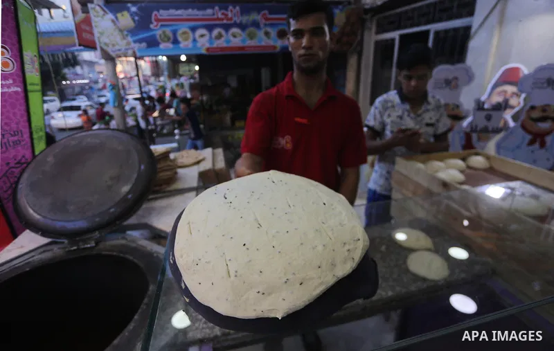 A Palestinian vendor prepares traditional bread known as "saj" for breakfasting on the Muslim holy fasting month of Ramadan in Gaza city on June 6, 2017. Ramadan is sacred to Muslims because it is during that month that...