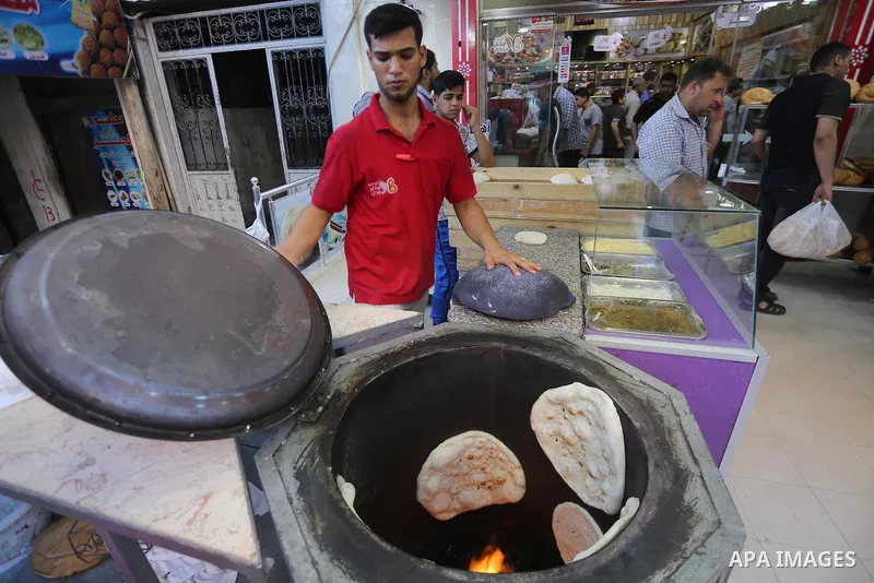 A Palestinian vendor prepares traditional bread known as "saj" for breakfasting on the Muslim holy fasting month of Ramadan in Gaza city on June 6, 2017. Ramadan is sacred to Muslims because it is during that month that...