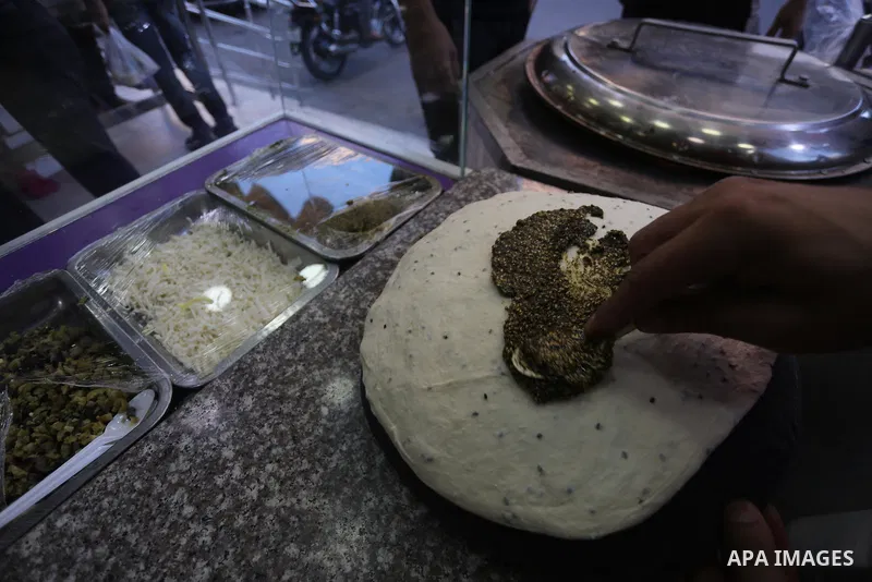 A Palestinian vendor prepares traditional bread known as "saj" for breakfasting on the Muslim holy fasting month of Ramadan in Gaza city on June 6, 2017. Ramadan is sacred to Muslims because it is during that month that...