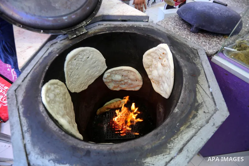 A Palestinian vendor prepares traditional bread known as "saj" for breakfasting on the Muslim holy fasting month of Ramadan in Gaza city on June 6, 2017. Ramadan is sacred to Muslims because it is during that month that...