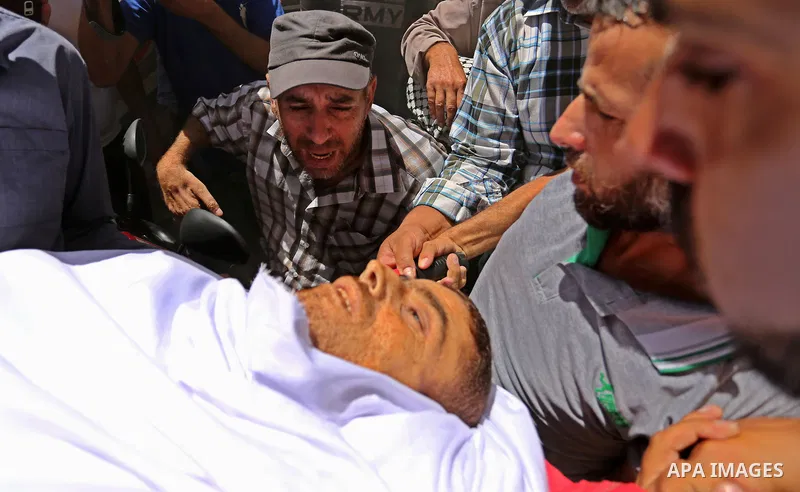 Mourners carry the body of a 25-year-old Palestinian Fadi al-Najjar who was killed by Israeli fire in the Gaza Strip during clashes with Israeli sceurity forces at the border fence the previous day, during his funeral in...