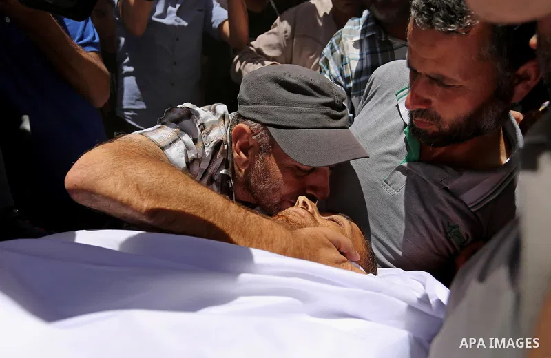 Mourners carry the body of a 25-year-old Palestinian Fadi al-Najjar who was killed by Israeli fire in the Gaza Strip during clashes with Israeli sceurity forces at the border fence the previous day, during his funeral in...
