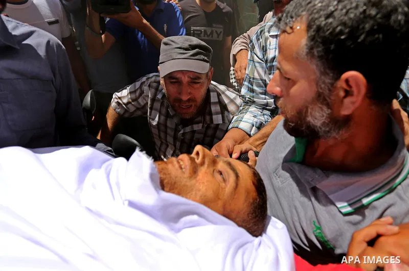 Mourners carry the body of a 25-year-old Palestinian Fadi al-Najjar who was killed by Israeli fire in the Gaza Strip during clashes with Israeli sceurity forces at the border fence the previous day, during his funeral in...
