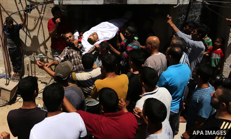 Mourners carry the body of a 25-year-old Palestinian Fadi al-Najjar who was killed by Israeli fire in the Gaza Strip during clashes with Israeli sceurity forces at the border fence the previous day, during his funeral in...