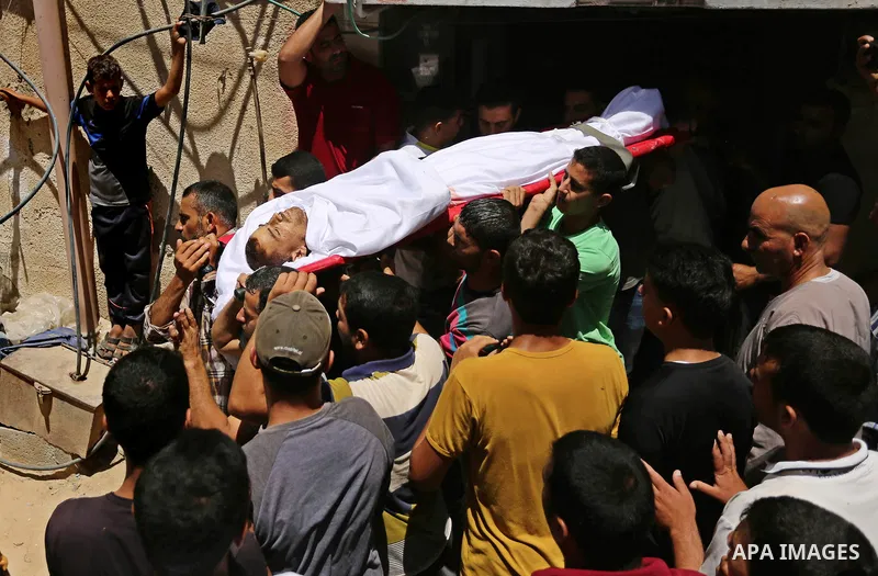 Mourners carry the body of a 25-year-old Palestinian Fadi al-Najjar who was killed by Israeli fire in the Gaza Strip during clashes with Israeli sceurity forces at the border fence the previous day, during his funeral in...