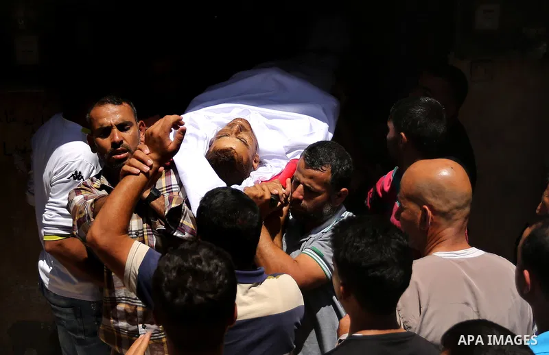 Mourners carry the body of a 25-year-old Palestinian Fadi al-Najjar who was killed by Israeli fire in the Gaza Strip during clashes with Israeli sceurity forces at the border fence the previous day, during his funeral in...