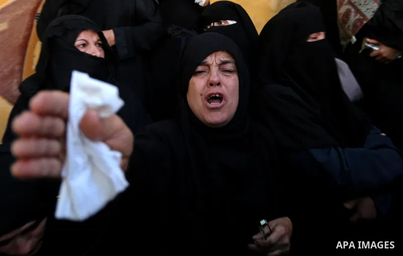 A Palestinian woman reacts during the funeral of a 25-year-old Palestinian Fadi al-Najjar who was killed by Israeli fire in the Gaza Strip during clashes with Israeli sceurity forces at the border fence the previous day,...