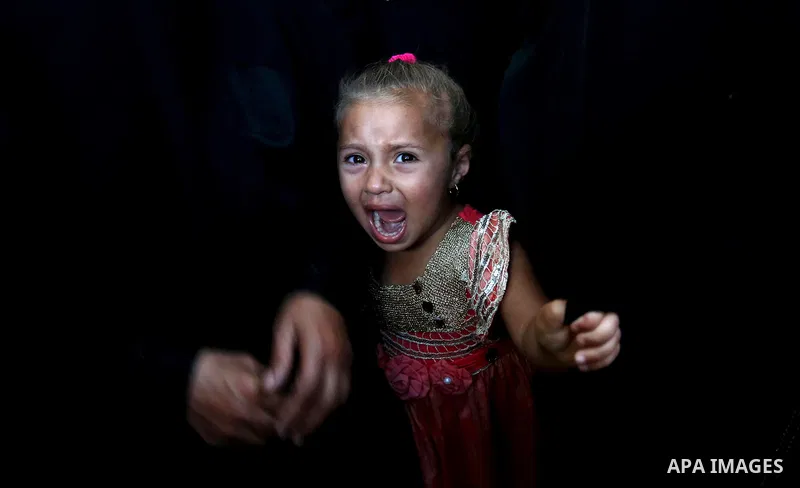 A Palestinian girls reacts during the funeral of a 25-year-old Palestinian Fadi al-Najjar who was killed by Israeli fire in the Gaza Strip during clashes with Israeli sceurity forces at the border fence the previous day,...