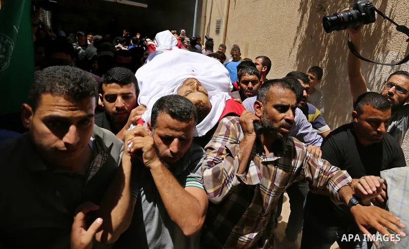 Mourners carry the body of a 25-year-old Palestinian Fadi al-Najjar who was killed by Israeli fire in the Gaza Strip during clashes with Israeli sceurity forces at the border fence the previous day, during his funeral in...