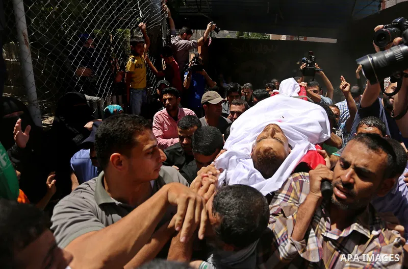 Mourners carry the body of a 25-year-old Palestinian Fadi al-Najjar who was killed by Israeli fire in the Gaza Strip during clashes with Israeli sceurity forces at the border fence the previous day, during his funeral in...