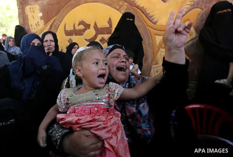 Palestinian women react during the funeral of a 25-year-old Palestinian Fadi al-Najjar who was killed by Israeli fire in the Gaza Strip during clashes with Israeli sceurity forces at the border fence the previous day, in...